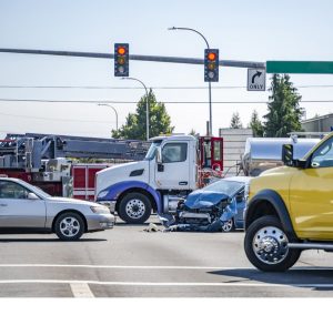 Cars and trucks at intersection with two red lights