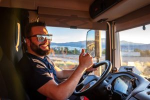 A truck driver gives a thumbs-up.