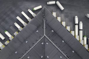 Tractor-trailers at a large loading dock.