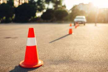 Road cones positioned in front of automobile to create obstacle course